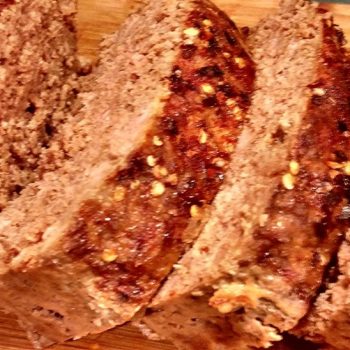 paprika dijon meatloaf slices on cutting board