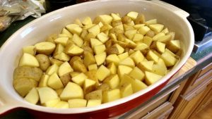 Cut potatoes and put in baking dish for roasted potatoes in oven recipe